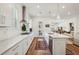 Modern kitchen with white cabinetry, stainless steel appliances, and a center island at 115 Ivey Way, Woodstock, GA 30188