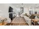 Inviting living room featuring a fireplace, hardwood floors, and modern decor, perfect for relaxation at 115 Ivey Way, Woodstock, GA 30188