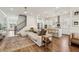 Spacious living room with hardwood floors, modern lighting, open to the kitchen and staircase at 115 Ivey Way, Woodstock, GA 30188