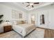 Comfortable primary bedroom featuring a ceiling fan, and access to the bathroom at 115 Ivey Way, Woodstock, GA 30188
