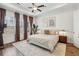Main bedroom with tray ceiling, ceiling fan, and large windows at 115 Ivey Way, Woodstock, GA 30188