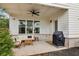 Covered patio with stylish seating, ceiling fan, and outdoor grill perfect for relaxing at 115 Ivey Way, Woodstock, GA 30188