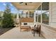 Covered patio with comfortable seating, decorative brick, and an inviting outdoor space at 115 Ivey Way, Woodstock, GA 30188