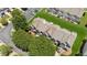 Aerial view of a townhouse community with manicured lawns, parking areas, and mature trees at 299 Azalea Cir, Cumming, GA 30040