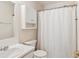 Practical bathroom with white fixtures, including a sink, toilet, and shower with curtain at 299 Azalea Cir, Cumming, GA 30040