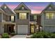 Charming two-story townhouse with a well-manicured front yard at sunset at 299 Azalea Cir, Cumming, GA 30040