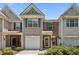 Charming two-story townhouse with a well-manicured front yard in daylight at 299 Azalea Cir, Cumming, GA 30040