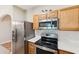 Well-equipped kitchen featuring stainless steel appliances and white subway tile backsplash at 299 Azalea Cir, Cumming, GA 30040