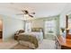 Well-lit main bedroom with ceiling fan, large windows, and pleasant, cozy design at 299 Azalea Cir, Cumming, GA 30040