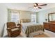 Comfortable main bedroom with furniture and decor, including a recliner and ceiling fan at 299 Azalea Cir, Cumming, GA 30040