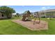 Community playground featuring a swing set, slide, and plenty of green space at 299 Azalea Cir, Cumming, GA 30040