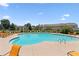 Community pool with blue water and lots of orange lounge chairs for relaxation at 299 Azalea Cir, Cumming, GA 30040