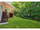 A well-maintained backyard with a lush green lawn and a wooden deck, offering a serene outdoor space at 384 Daniel Mill Xing, Villa Rica, GA 30180
