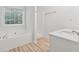 Bright bathroom with a soaking tub, separate shower, and vanity, creating a spa-like experience at 384 Daniel Mill Xing, Villa Rica, GA 30180