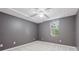 Bedroom featuring modern ceiling fan, plush carpeting, and natural light at 384 Daniel Mill Xing, Villa Rica, GA 30180