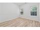 Bright bedroom with hardwood floors, two windows, and neutral paint, creating a serene space at 384 Daniel Mill Xing, Villa Rica, GA 30180