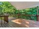 A beautiful wooden deck offers a perfect space for outdoor relaxation surrounded by lush greenery at 384 Daniel Mill Xing, Villa Rica, GA 30180