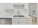 Close-up of a kitchen sink area with white cabinets, stainless steel appliances, and subway tile backsplash at 384 Daniel Mill Xing, Villa Rica, GA 30180