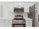 Modern kitchen with stainless steel appliances and bright white subway tile backsplash at 384 Daniel Mill Xing, Villa Rica, GA 30180