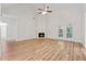 Spacious living room with wood floors, a fireplace, and French doors that let in natural light at 384 Daniel Mill Xing, Villa Rica, GA 30180