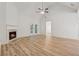Inviting living room featuring vaulted ceilings, wood floors, a fireplace, and plenty of natural light at 384 Daniel Mill Xing, Villa Rica, GA 30180