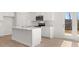 Modern white kitchen featuring stainless steel appliances, a functional island, and ample storage at 4455 Manor Hill Dr, Union City, GA 30291