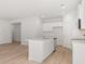 Open-concept kitchen with a spacious island, stainless steel appliances, and elegant white cabinetry at 4455 Manor Hill Dr, Union City, GA 30291