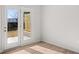 Bright room with wood laminate flooring and glass doors leading to outdoor patio at 4455 Manor Hill Dr, Union City, GA 30291