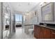 Modern bathroom with marble tile, glass shower, dark vanity, and view to bedroom at 1080 Peachtree Ne St # 2710, Atlanta, GA 30309