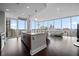 Sunlit living area with a wraparound balcony access, connected to a functional kitchen and city views at 1080 Peachtree Ne St # 2710, Atlanta, GA 30309