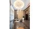 Bright lobby featuring modern chandelier, seating area, and unique wall textures at 1080 Peachtree Ne St # 2710, Atlanta, GA 30309
