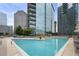 Relaxing pool with lounge chairs and a view of the city skyline at 1080 Peachtree Ne St # 2710, Atlanta, GA 30309