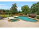 Backyard pool and spa with lounge chairs, mature landscaping, and a wooden privacy fence at 4045 Boles Creek Dr, Duluth, GA 30096