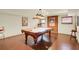 Basement game room featuring a vintage pool table, exposed brick, and unique overhead lighting at 4045 Boles Creek Dr, Duluth, GA 30096