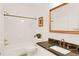 A bathroom with a shower/tub, classic vanity, and gold hardware fixtures at 4045 Boles Creek Dr, Duluth, GA 30096