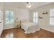 A bedroom featuring beautiful hardwood floors, bright windows with shutters, and classic decor at 4045 Boles Creek Dr, Duluth, GA 30096