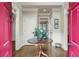 Welcoming foyer with hardwood floors, a center table with flowers, and neutral wall colors at 4045 Boles Creek Dr, Duluth, GA 30096