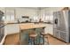 Bright kitchen with white cabinets, a central island, and stainless steel appliances at 4045 Boles Creek Dr, Duluth, GA 30096
