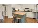 Gourmet kitchen featuring white cabinets, a center island, and stainless steel appliances at 4045 Boles Creek Dr, Duluth, GA 30096