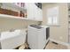 Functional laundry room featuring modern washer and dryer, and ample storage at 4045 Boles Creek Dr, Duluth, GA 30096