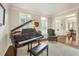 Sophisticated living room with a grand piano, shuttered windows, and elegant decor at 4045 Boles Creek Dr, Duluth, GA 30096