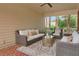 Relaxing covered patio featuring comfortable seating and a stylish gold coffee table at 4045 Boles Creek Dr, Duluth, GA 30096