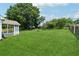 Expansive backyard featuring lush green grass, mature trees and a charming screened in porch at 4369 Milford Pl, Hoschton, GA 30548