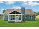 The home's backyard featuring an enclosed porch and large yard with a tall privacy fence at 4369 Milford Pl, Hoschton, GA 30548
