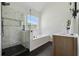Bathroom featuring glass enclosed shower, soaking tub and large window at 4369 Milford Pl, Hoschton, GA 30548