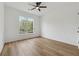 Bright and airy bedroom features a ceiling fan, large windows, and wood flooring at 4369 Milford Pl, Hoschton, GA 30548