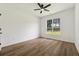 Spacious bedroom features wood-look floors, large windows, and a ceiling fan at 4369 Milford Pl, Hoschton, GA 30548