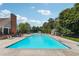Large community pool surrounded by lounge chairs and greenery, perfect for enjoying the outdoors at 4369 Milford Pl, Hoschton, GA 30548