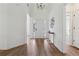 Bright and airy entryway featuring stylish decor, light hardwood flooring, and a view into the open-concept living spaces at 4369 Milford Pl, Hoschton, GA 30548