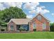 Charming brick home with manicured lawn and garden beds, showcasing curb appeal and a welcoming facade at 4369 Milford Pl, Hoschton, GA 30548